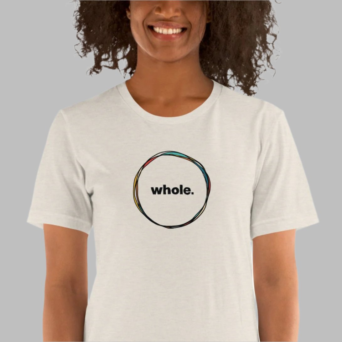 off-white color heather tee with a hand-drawn circle with the word, whole, in the middle on a model