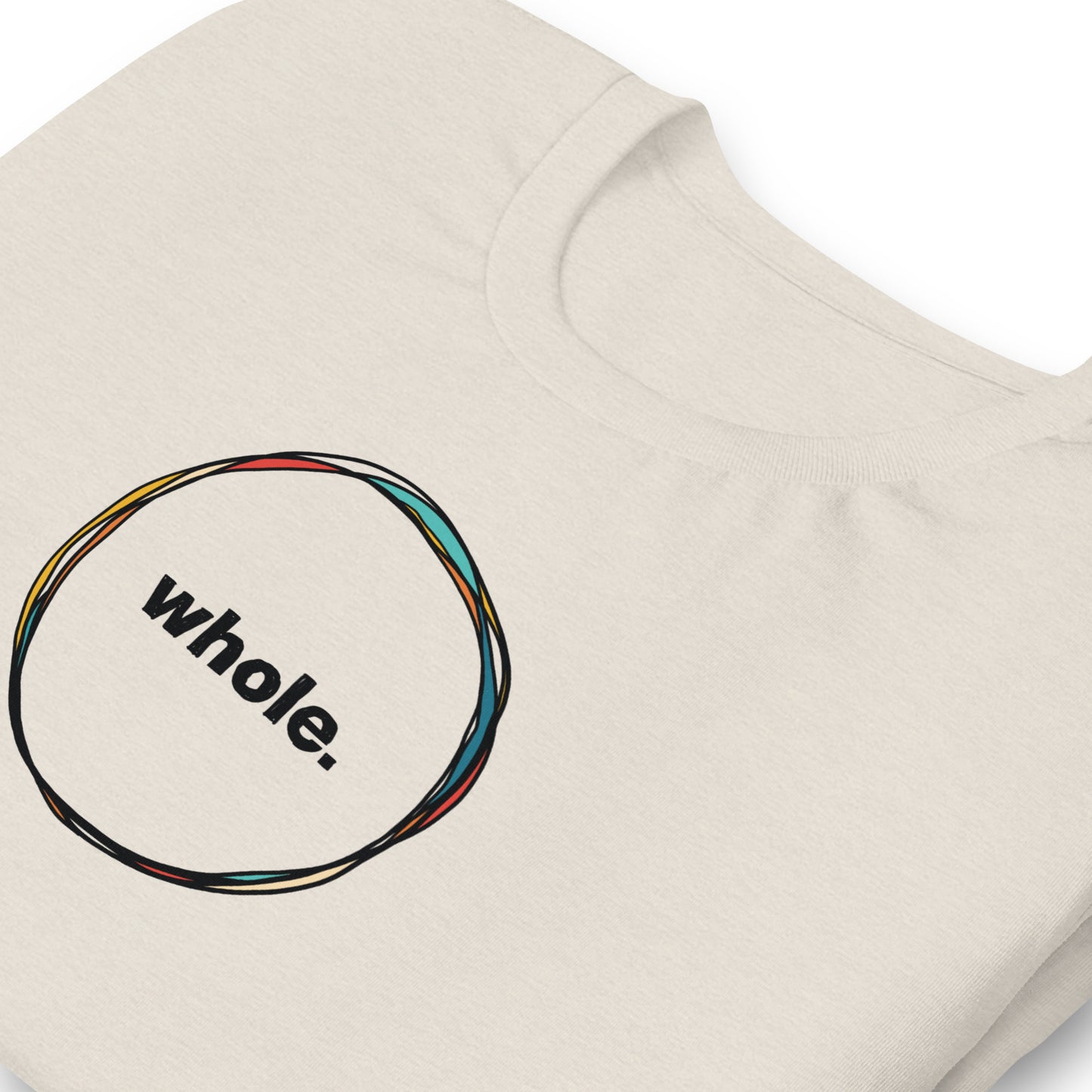 close up of off-white color heather tee with a hand-drawn circle with the word, whole, in the middle
