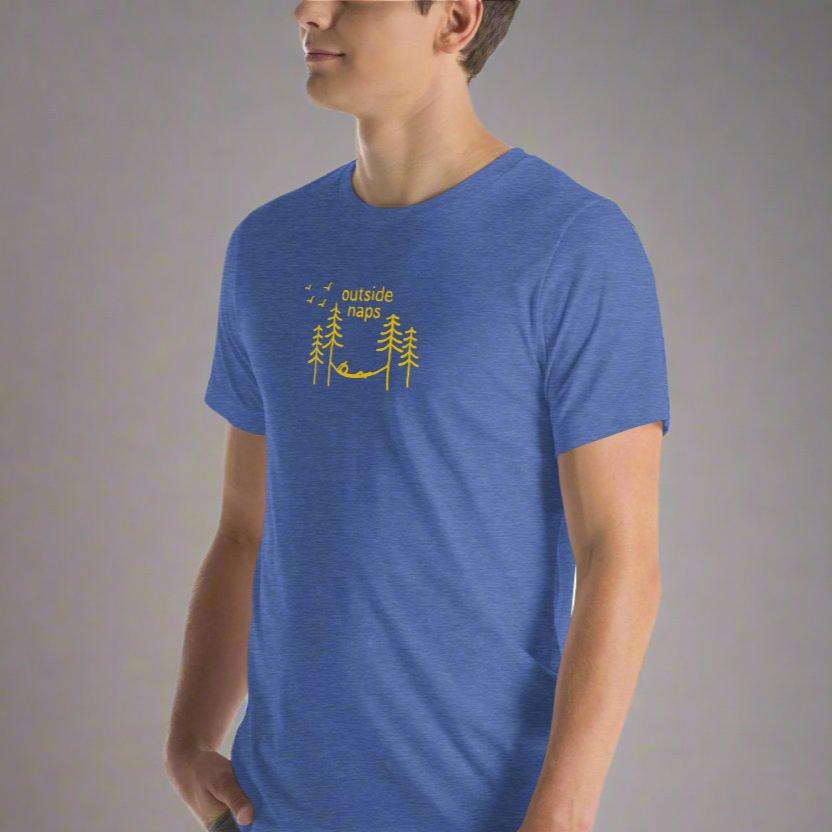 Royal blue color heather shirt with a yellow hand drawn illustration of someone laying in a hammock in the trees on male model