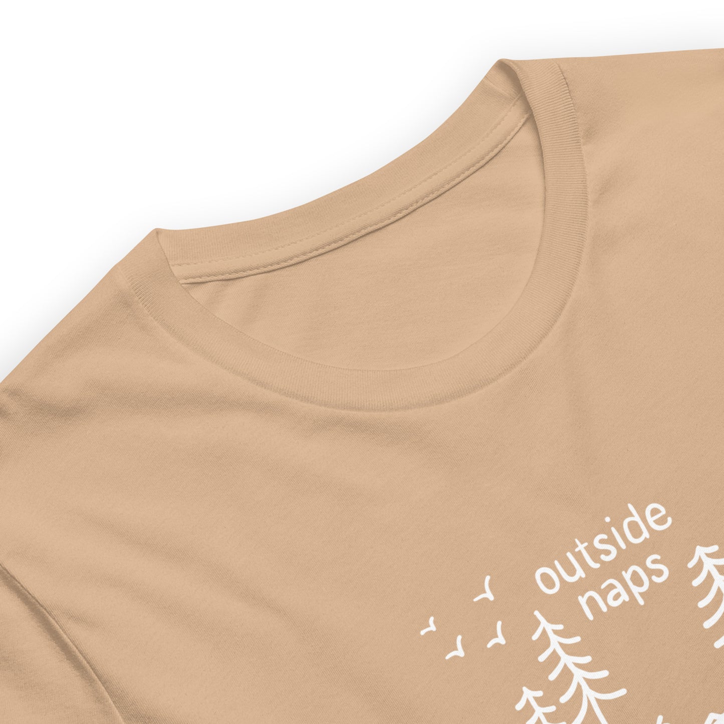 close up of tan cotton tee with hand-drawn illustration of a person laying in a hammock in the trees in white